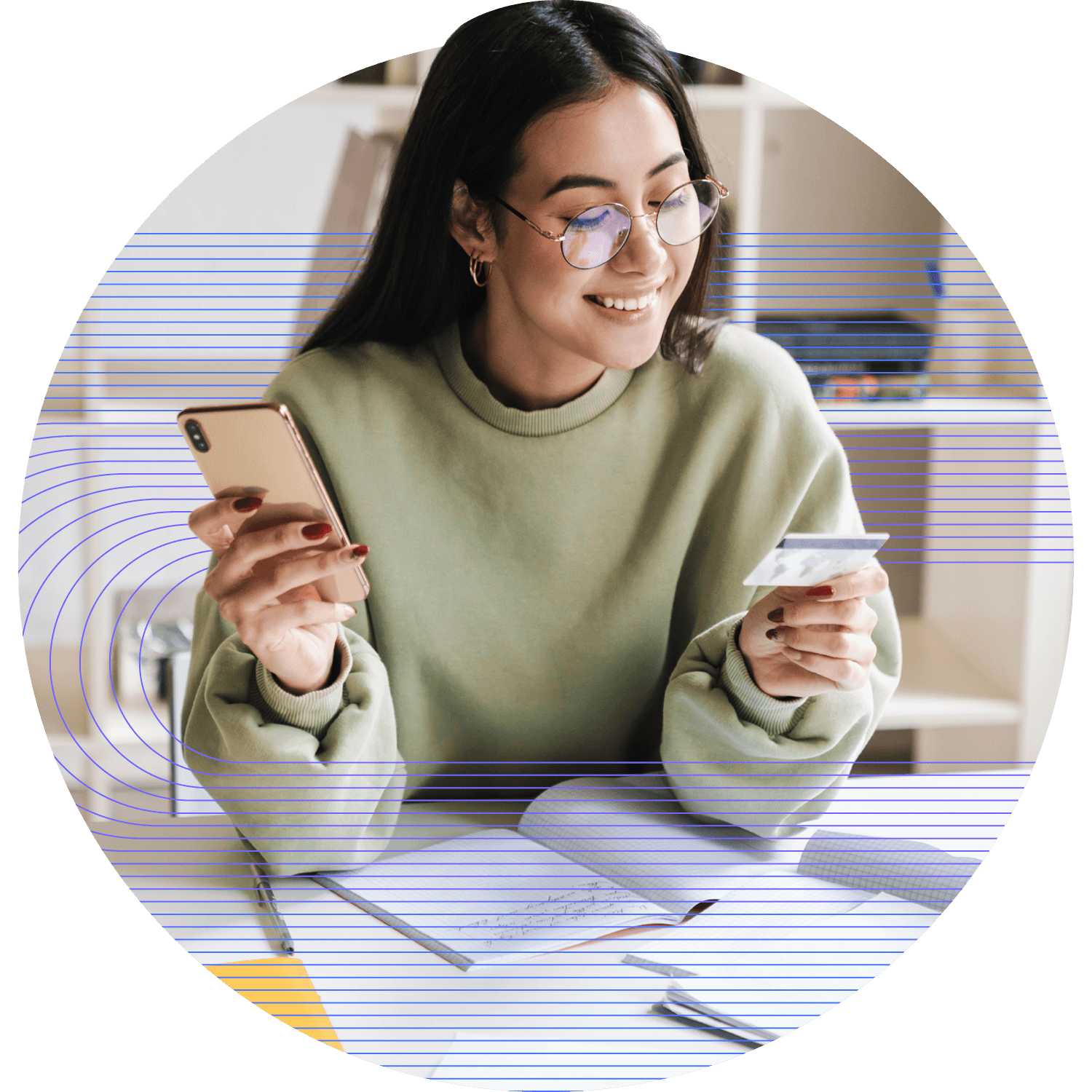 Woman holding up and looking at credit card on left hand while holder phone on right hand